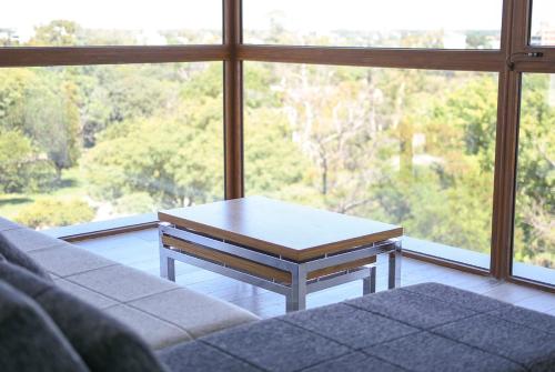 a living room with a coffee table in front of a window at Aizarker in La Plata