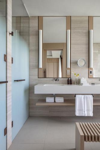 a bathroom with a sink and a mirror at Silversands Resort Grenada at Grand Anse in Grand Anse