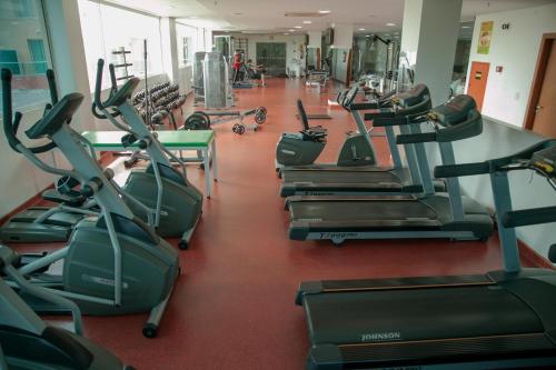 a gym with a row of cardio machines at Arrey Gran Hotel in Teresina