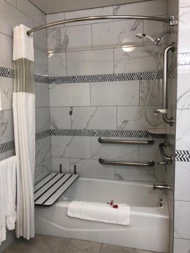 a white bathroom with a tub and a shower at Triplodge of Santa Clarita in Santa Clarita