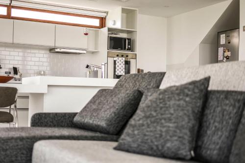 a couch with three pillows on it in a kitchen at Aizarker in La Plata
