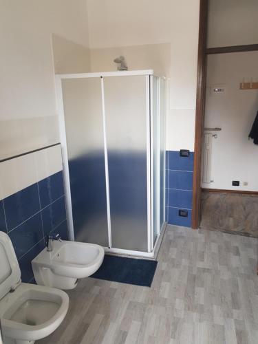 a bathroom with two toilets and a shower at Foresteria Giulia in Bergamo