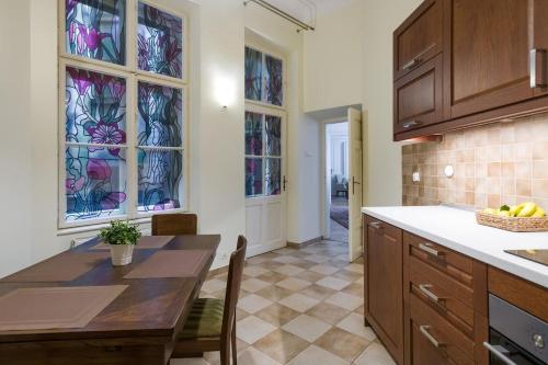 a kitchen with a table and chairs and stained glass windows at Belle Epoque II, luxury suite 50m to Main Square in Krakow