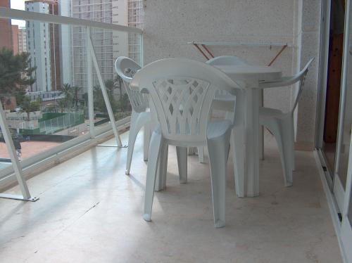 a white table and chairs on a balcony at Vacanza Complex in Benidorm