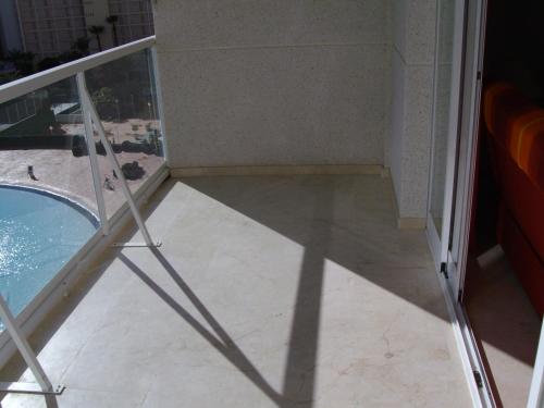 a bathroom with a glass door and a swimming pool at Vacanza Complex in Benidorm