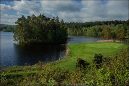 a golf course next to a large body of water at Varbergs GK Östra Hotell in Grimeton