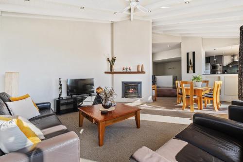a living room with a couch and a table at Oriwa View in Queenstown
