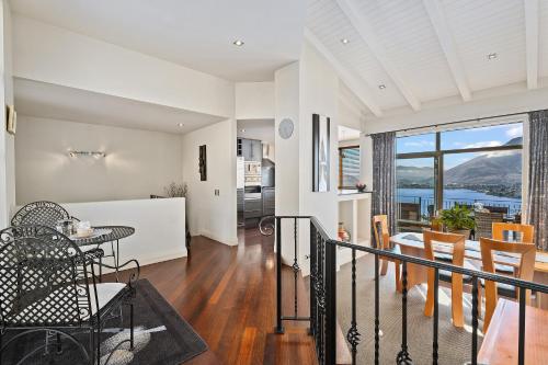 a living room and dining room with a view of the ocean at Oriwa View in Queenstown