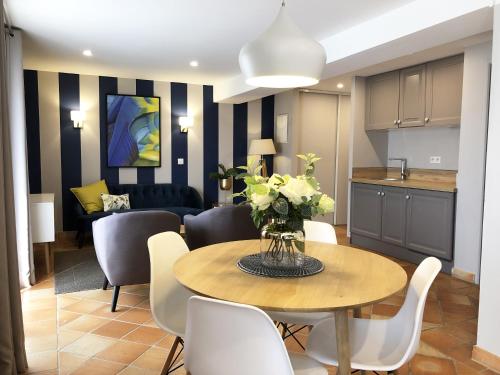 a kitchen and dining room with a table and chairs at Hotel Les Suites - Domaine de Crécy in Crecy la Chapelle
