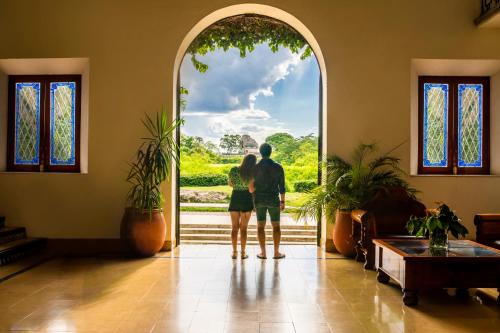 a couple standing in front of an open door at Mayaland Hotel & Bungalows in Chichén-Itzá