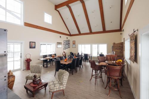 a dining room with tables and chairs and windows at The Barn B&B Walla Walla in Walla Walla
