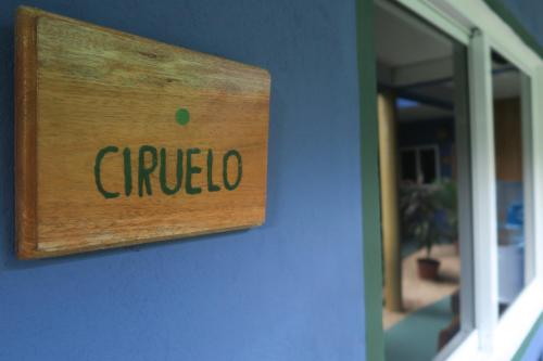 a sign that reads chued on the side of a building at Casa Almendro in Tulum