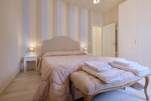 a bedroom with a large bed with towels on it at Family Apartment Fucecchio in Fucecchio