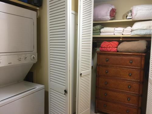 a bathroom with a closet with a dresser and towels at 9B EKAHI VILLAGE-STUDIO BATH, GARDEN VIEW - 1 MINUTE STROLL to BEACH! in Wailea