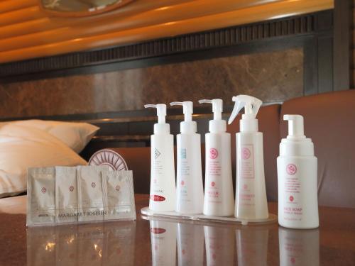 a group of four bottles of lotion on a table at ホテルファインシエル鳥取砂丘店 - 大人専用 in Tottori