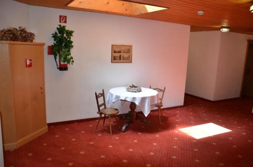 a room with a table and two chairs in a room at Posthotel Rössle in Gaschurn