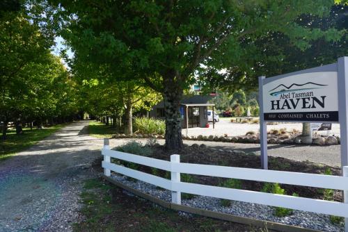 a sign for a hawen outpatient clinic next to a fence at Abel Tasman Haven in Marahau
