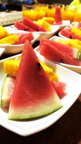 a plate of watermelon and other fruit on a table at Casa Jungle Monteverde B&B in Monteverde Costa Rica