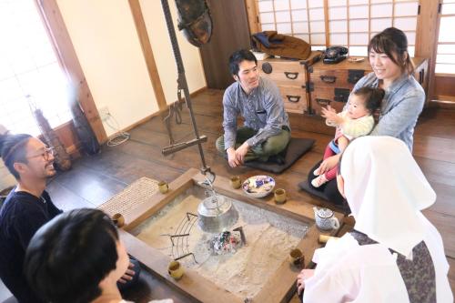a group of people sitting on the floor in a room at KOME HOME in Tokamachi