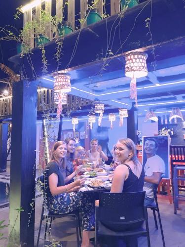 a group of people sitting at a dinner table at Sunny Riverside Homestay in Hoi An