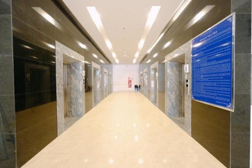 a hallway in a building with a sign on the wall at Stay in Nha Trang Apartment in Nha Trang