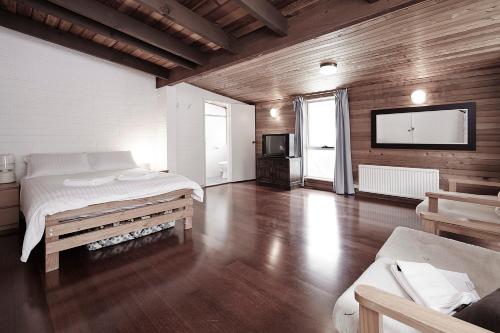 a bedroom with a bed and a flat screen tv at Moose 10 AMS Mt Buller in Mount Buller