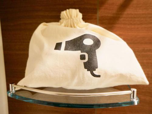 a white bag with a key painted on it at Henn na Hotel Tokyo Ginza in Tokyo