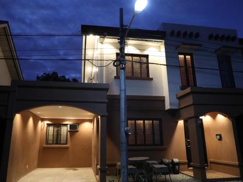 a house with a street light in front of it at Stay Amare Bayswater Mactan in Mactan