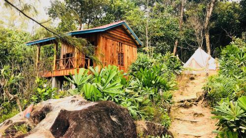 a small wooden house in the middle of a forest at Robinson Bungalows in Koh Rong Sanloem