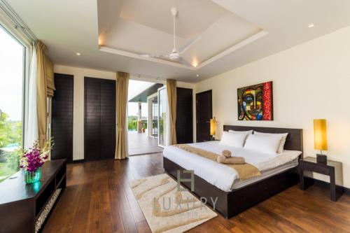a bedroom with a bed and a large window at 5 Bedroom Amazing Pool Villa In Resort TS1 in Hua Hin