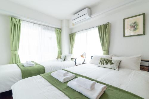 Postel nebo postele na pokoji v ubytování Uhome Iriya Apartment