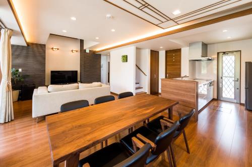 a living room with a dining table and a couch at E-horizon Resort 名護 in Nago