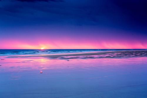 a sunset on a beach with the ocean at Ingenia Holidays Torquay Australia in Torquay