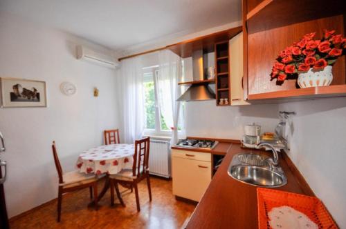 a kitchen with a table and a small table and chairs at Mira Apartments in Novigrad Istria
