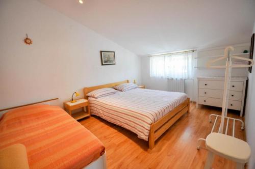 a bedroom with a bed and a chair in it at Mira Apartments in Novigrad Istria