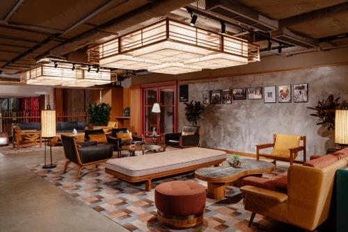 a living room with couches and tables and chairs at Eaton HK in Hong Kong