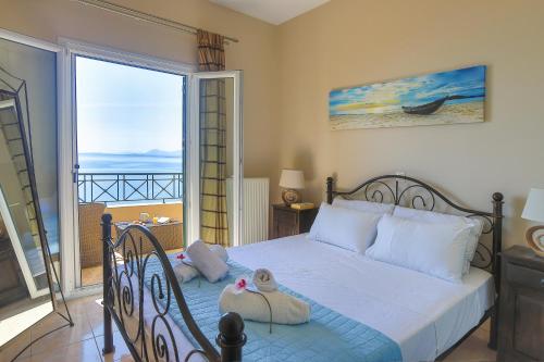 a bedroom with a bed with a view of the ocean at Villa Dimeli in Barbati