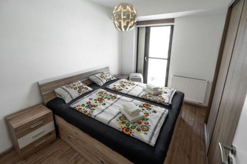 a bedroom with a bed and a chandelier at Old Town Luxury Apartment in heart of Bratislava in Bratislava
