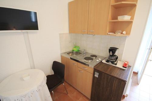 a small kitchen with a sink and a counter top at Mira Apartments in Novigrad Istria