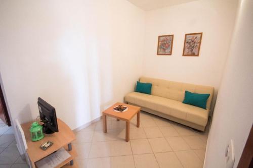 a living room with a couch and a table at Mira Apartments in Novigrad Istria