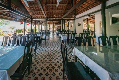 a dining room with tables and chairs in a restaurant at Ven Ven Hotel in Ho Coc