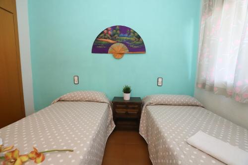 two beds sitting next to each other in a room at COSTA DAURADA APARTAMENTS - Marathon II in Salou