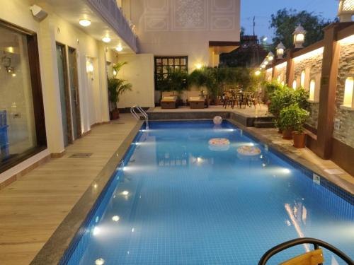 a swimming pool in the middle of a house at Laxmi Palace Heritage Boutique Hotel in Jaipur