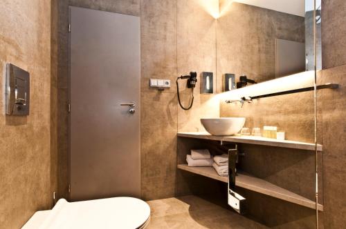 a bathroom with a shower and a toilet and a sink at Akcent hotel in Prague