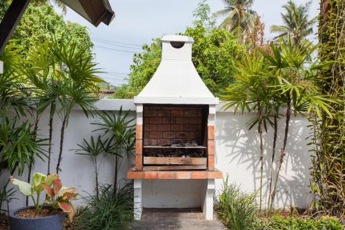 a brick oven in a garden with plants at Baan Santhiya Private Pool Villas - Free Tuk-Tuk Service to the Beach! in Ao Nang Beach