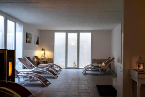 un grupo de sillas en una habitación con ventanas grandes en Agriturismo Villa Gaia, en Lonato