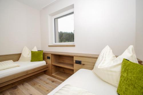 a living room with a couch and a window at Apartment Hotel Christine in Avelengo