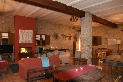 a living room with a couch and a fireplace at B&B El Ranxo in Franciach