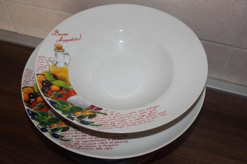 a white toilet seat with a picture of fruits on it at Apartments Kapisoda in Cetinje