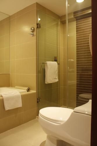 a bathroom with a toilet and a shower at Grand Noble Hotel Xi’an in Xi'an